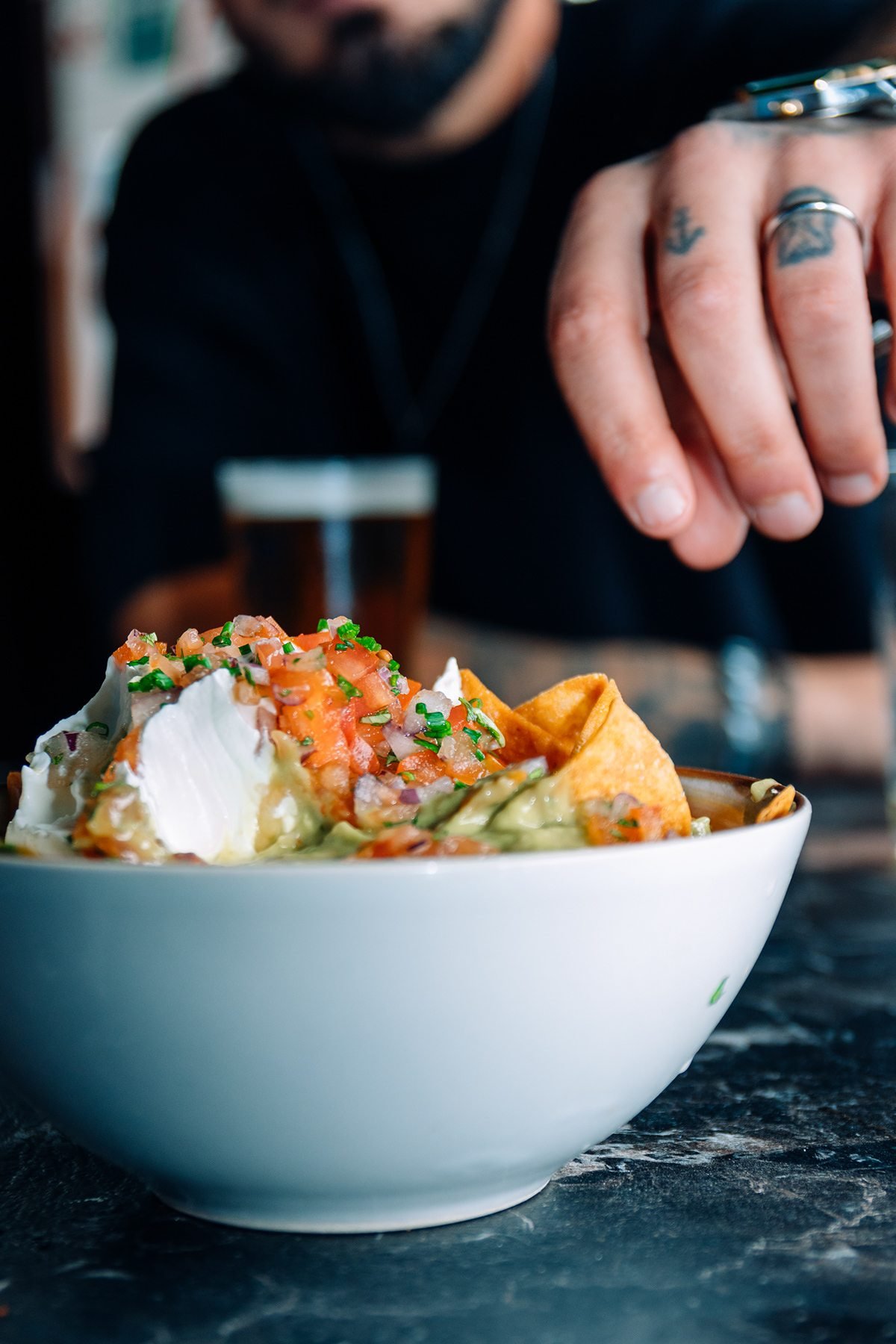 Mr Kong: bol de nachos con salsas sobre mesa de mármol negro