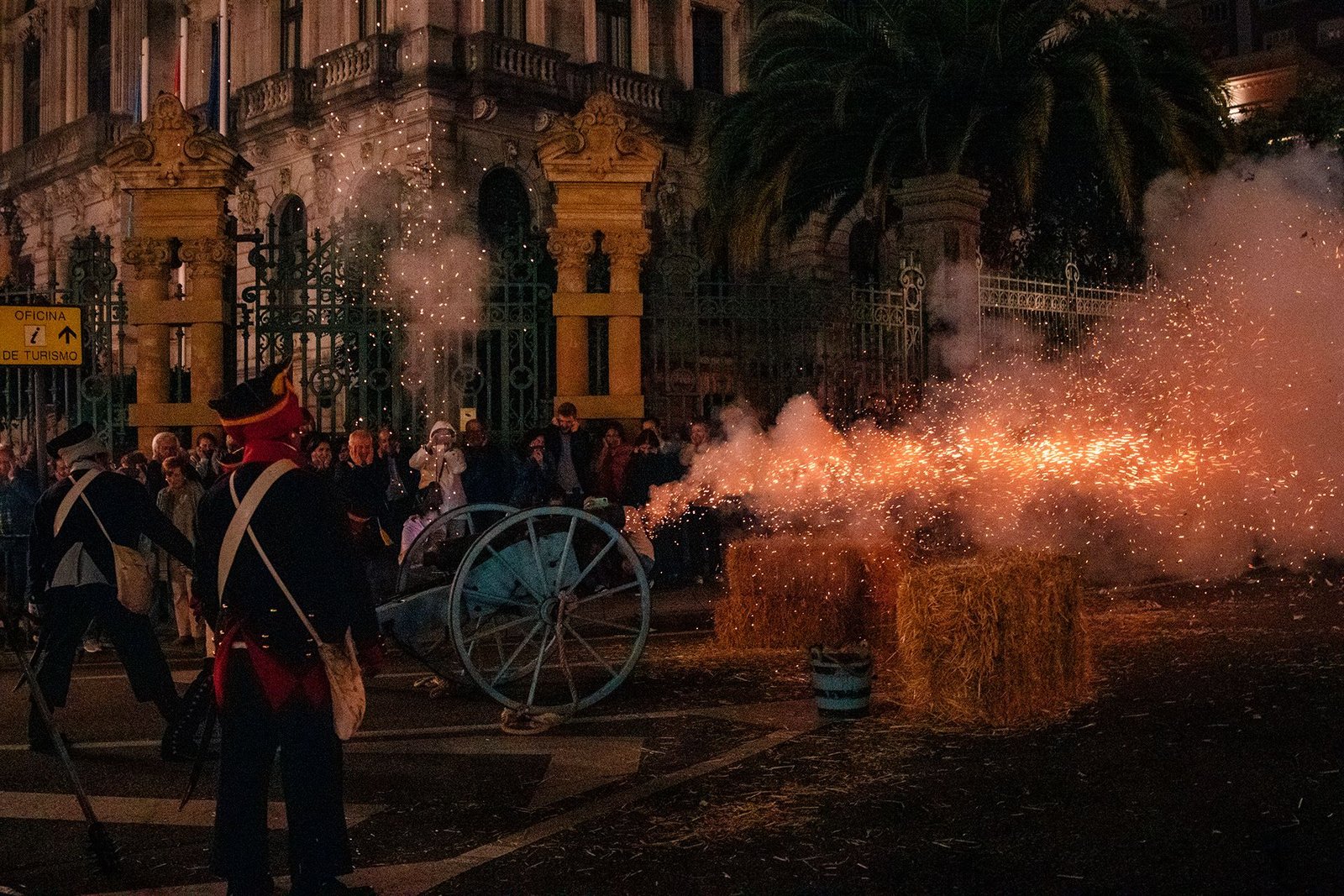 Participantes y público observan una escena iluminada del desfile.