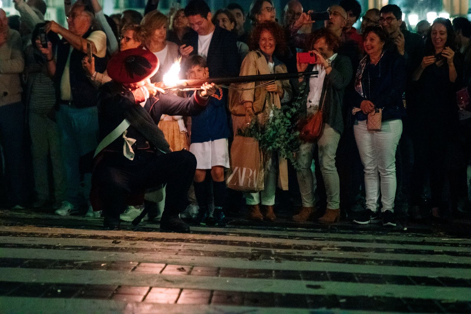 Participante sostiene una antorcha frente al público.